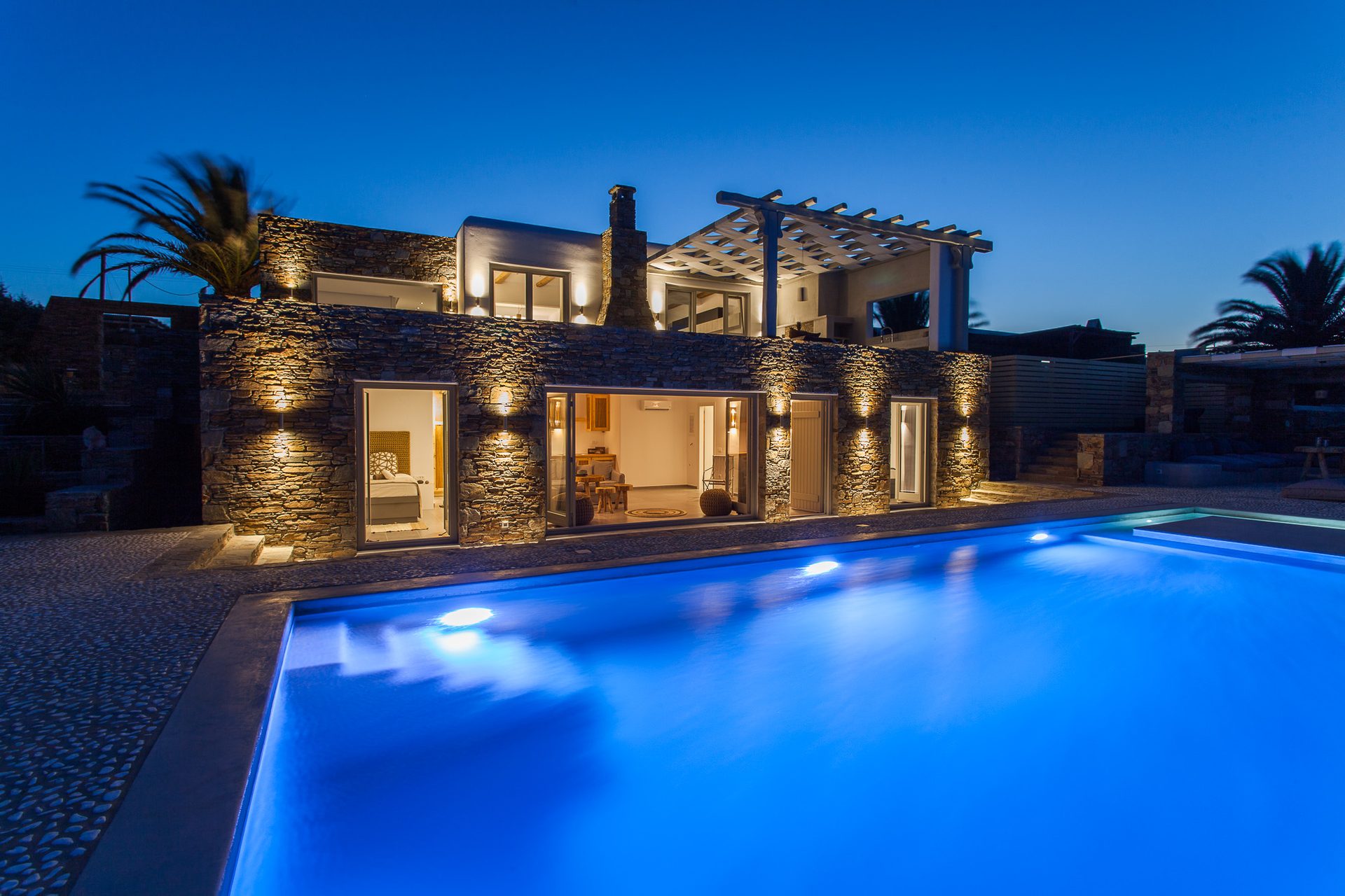 Pool and villa at dusk at Platinum Superior Villa in Kalafatis, Mykonos