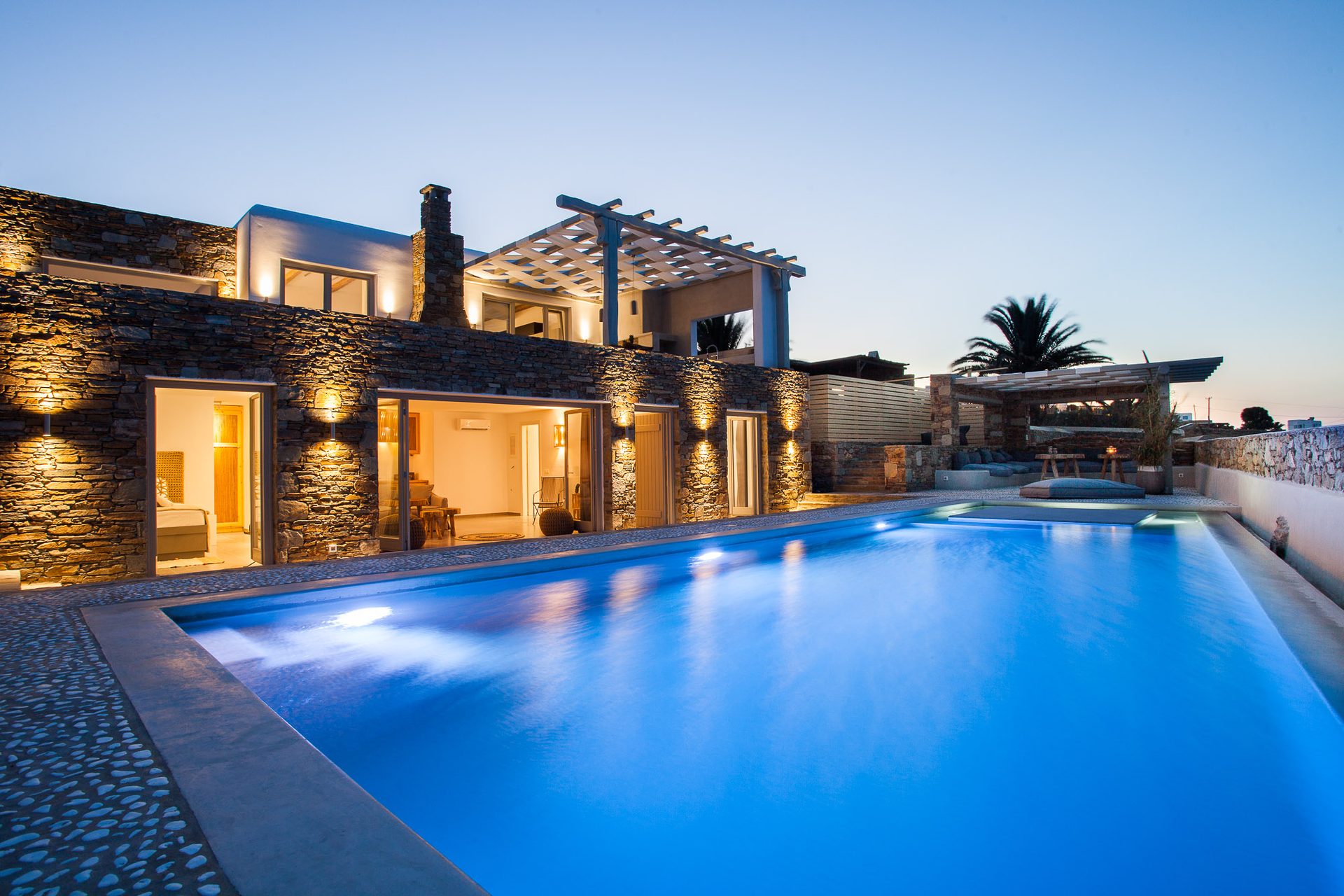 Pool lit at dusk at Platinum Superior Villa in Kalafatis, Mykonos