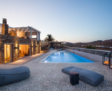 Pool terrace at dusk at Platinum Superior Villa in Kalafatis, Mykonos