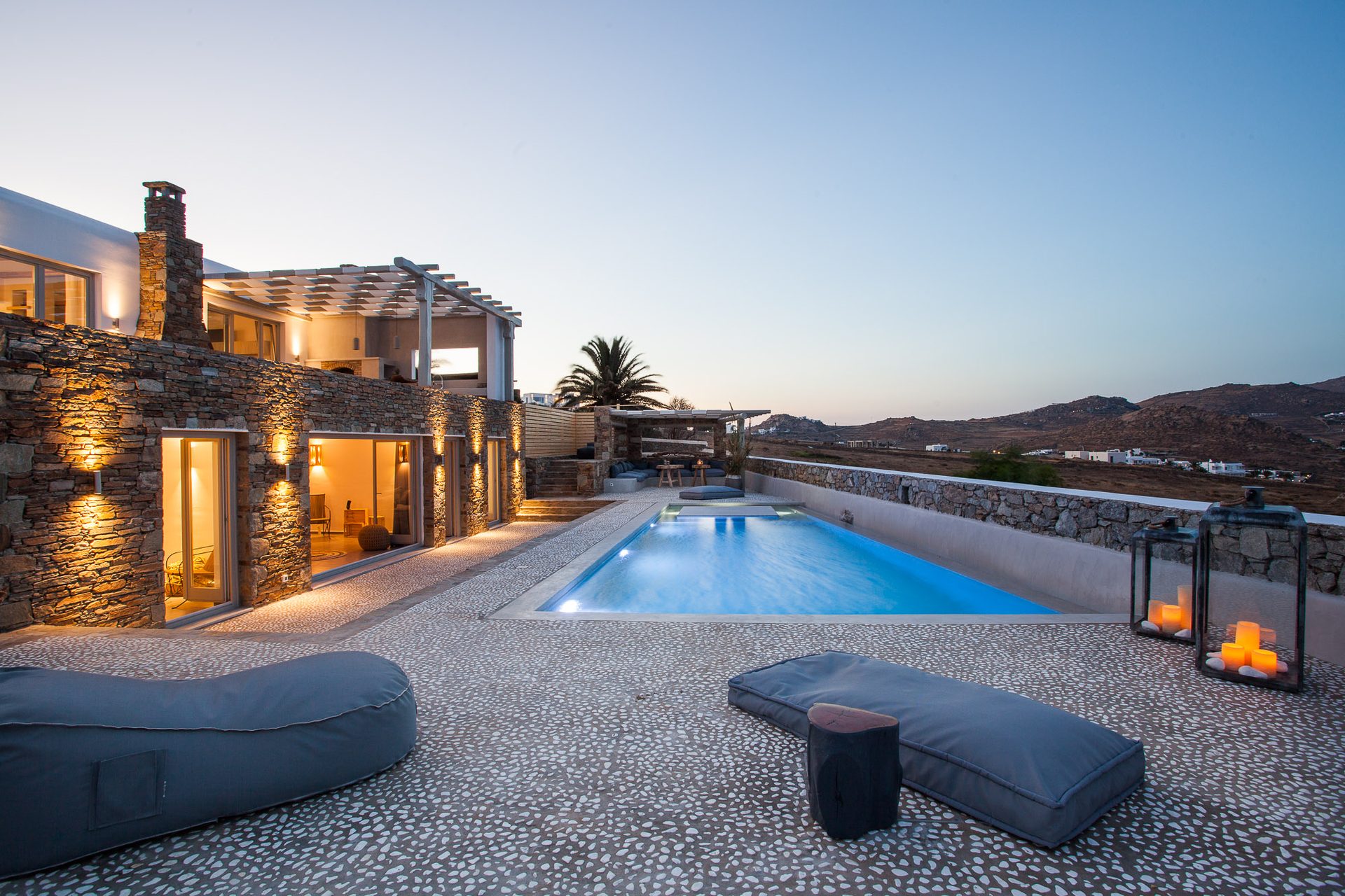 Pool terrace at dusk at Platinum Superior Villa in Kalafatis, Mykonos