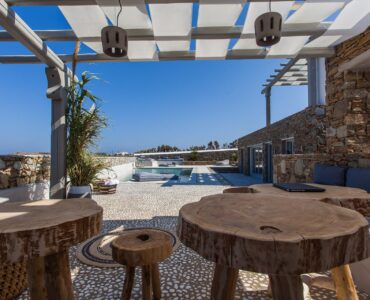 Outdoor tables under the pergola at Platinum Superior Villa in Kalafatis, Mykonos