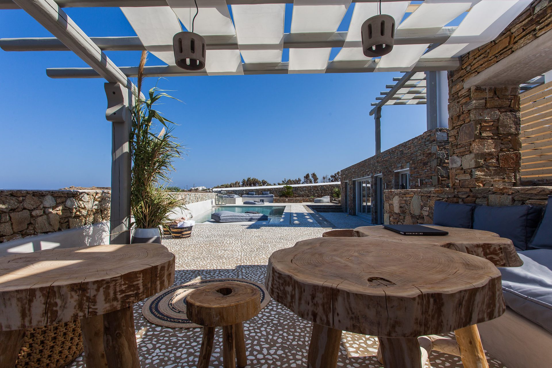Outdoor tables under the pergola at Platinum Superior Villa in Kalafatis, Mykonos