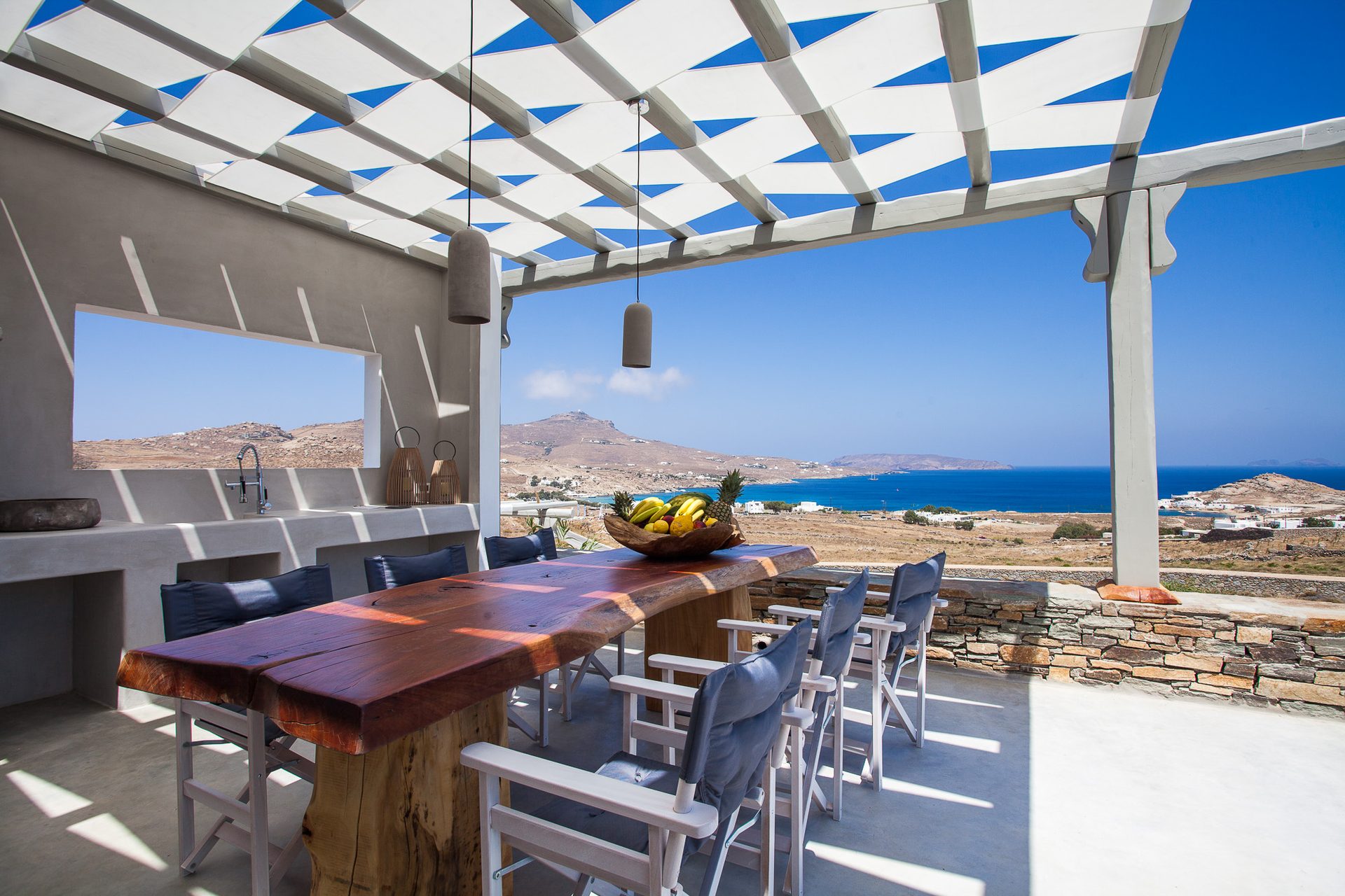 Outdoor dining with sea view at Platinum Superior Villa in Kalafatis, Mykonos