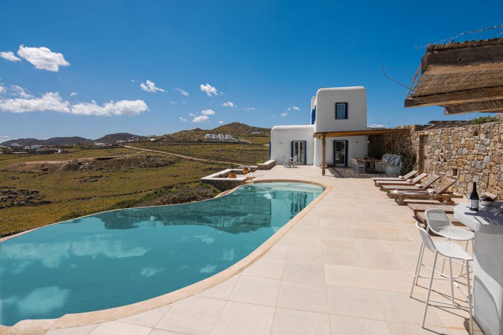 Free-form pool with sea and hill views at Tranquil Villa 5 in Kalafatis, Mykonos
