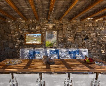 Stone-walled covered dining area at Tranquil Villa 5 in Kalafatis, Mykonos