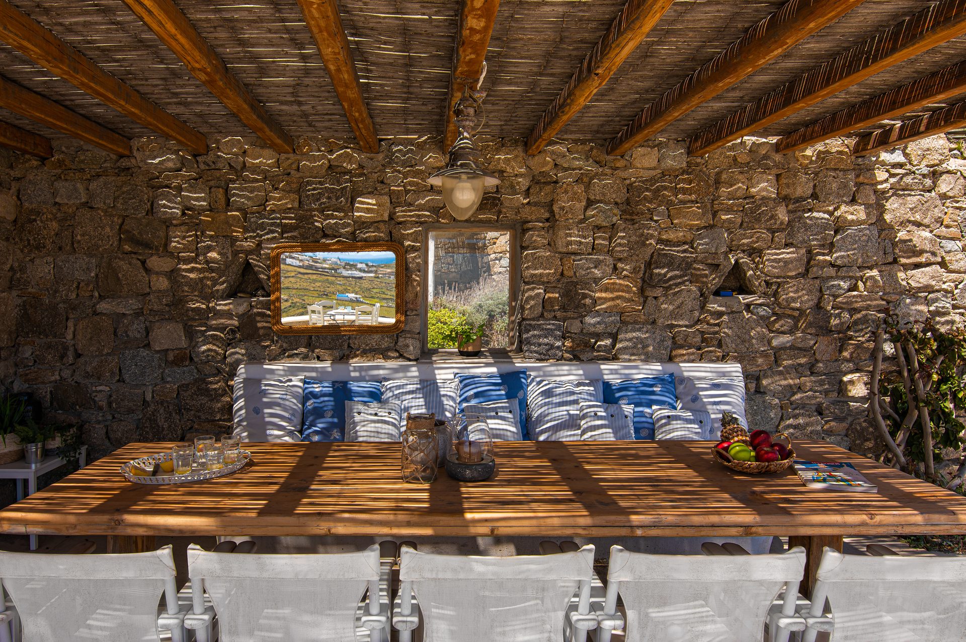 Stone-walled covered dining area at Tranquil Villa 5 in Kalafatis, Mykonos
