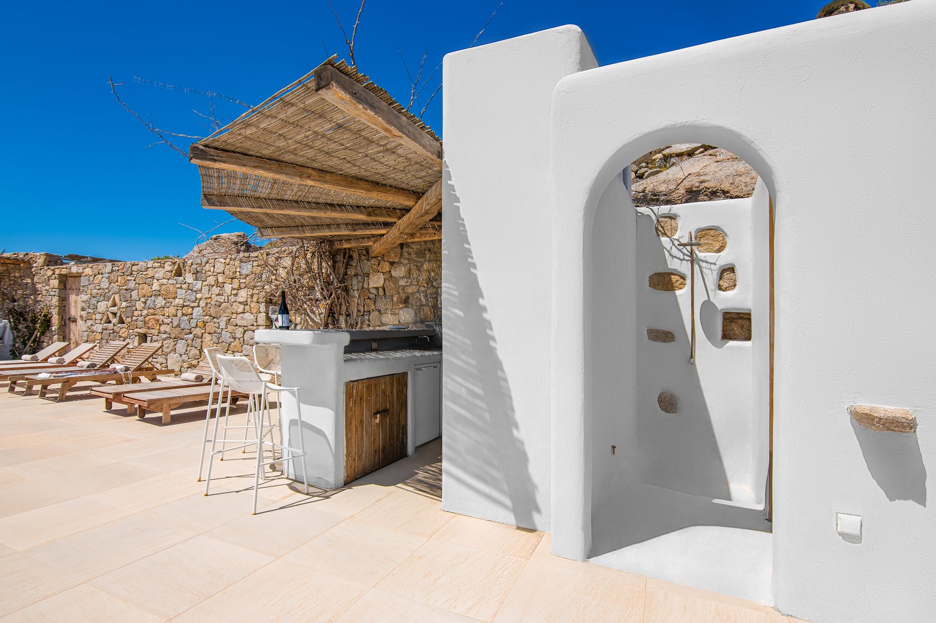 Whitewashed arch and pergola on the terrace at Tranquil Villa 5 in Kalafatis, Mykonos