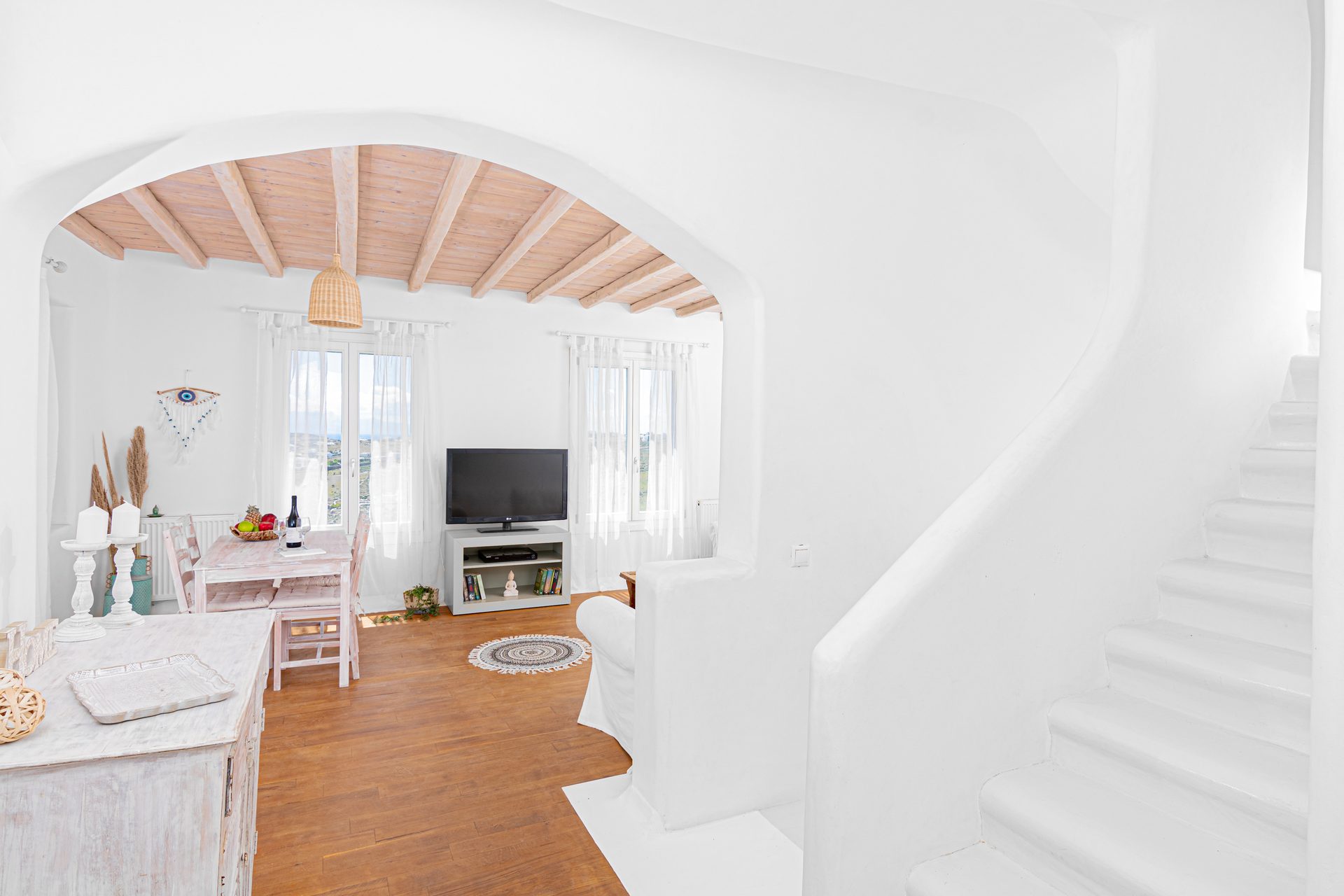 Living room with arched opening at Tranquil Villa 5 in Kalafatis, Mykonos