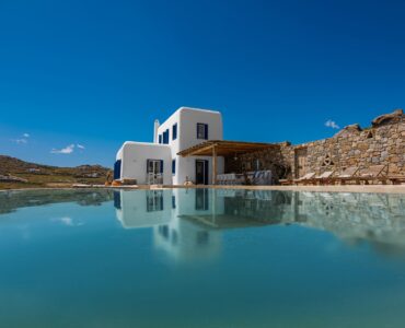 Pool and villa against the hills at Tranquil Villa 5 in Kalafatis, Mykonos