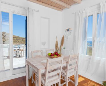 Dining table by the terrace doors at Tranquil Villa 5 in Kalafatis, Mykonos