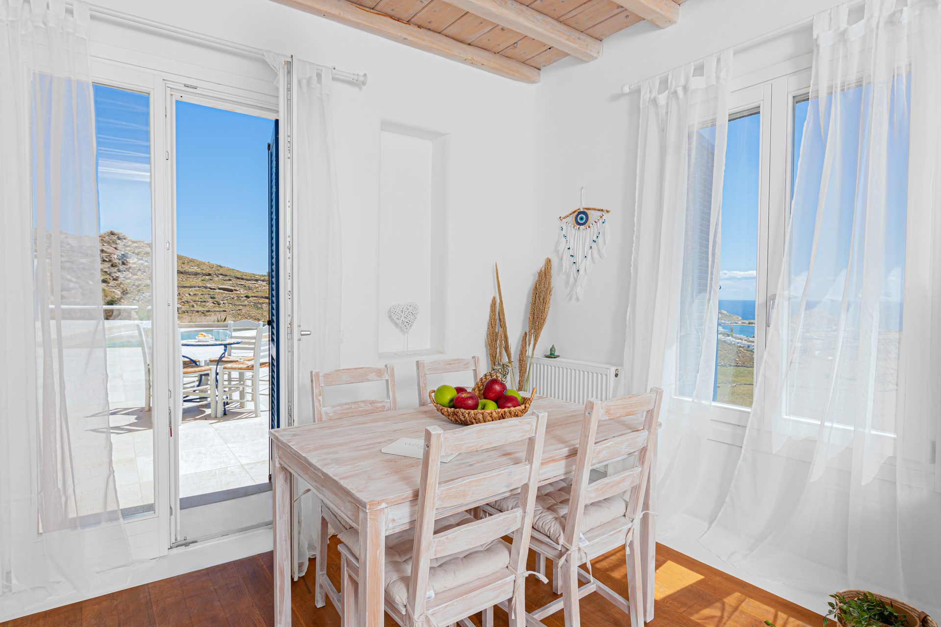 Dining table by the terrace doors at Tranquil Villa 5 in Kalafatis, Mykonos