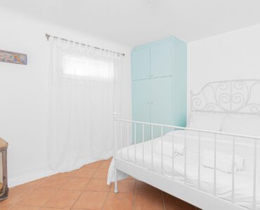 Bedroom with wardrobe at Tranquil Villa 5 in Kalafatis, Mykonos