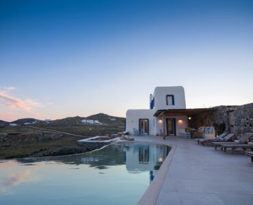 Pool and villa at dusk at Tranquil Villa 5 in Kalafatis, Mykonos