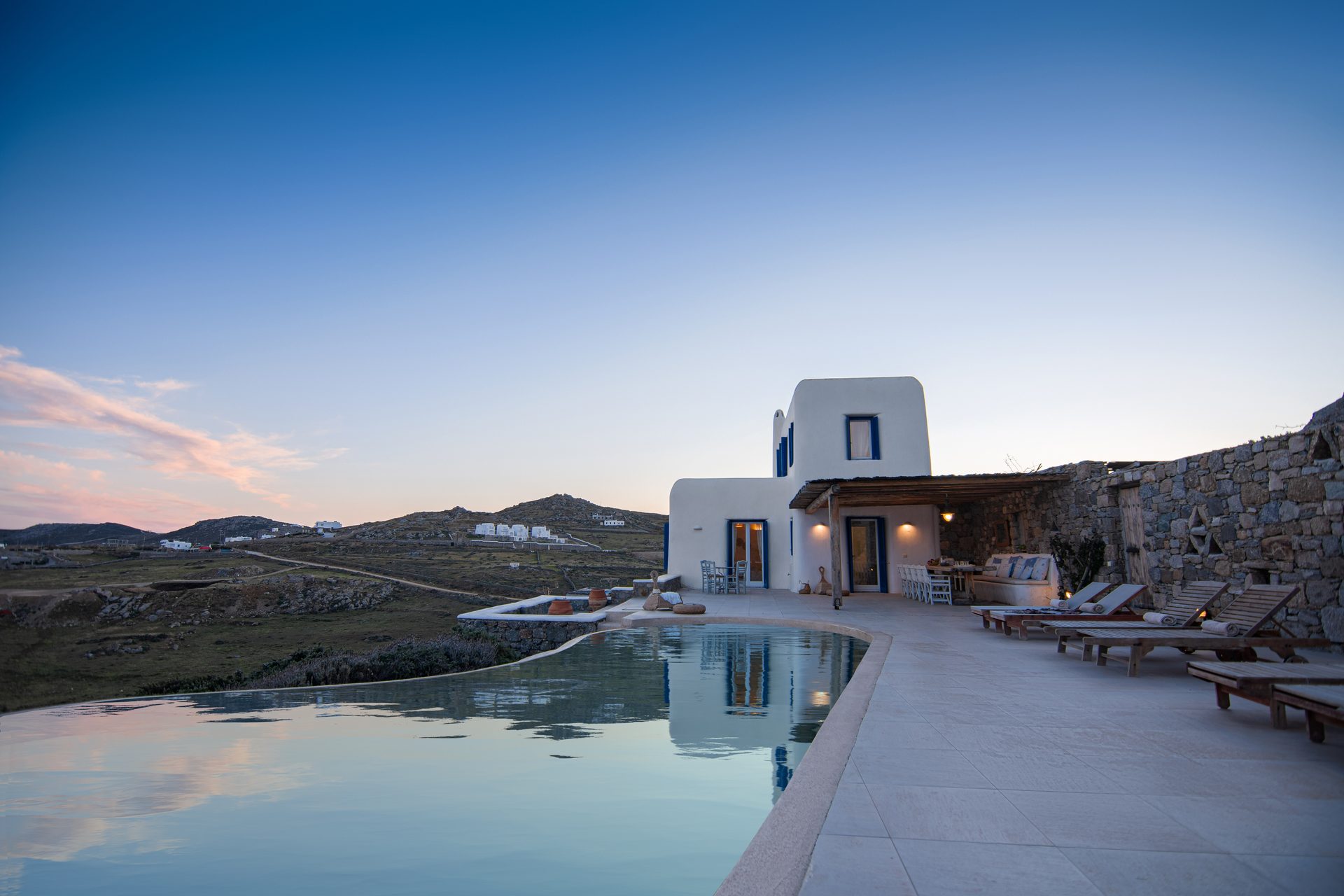 Pool and villa at dusk at Tranquil Villa 5 in Kalafatis, Mykonos