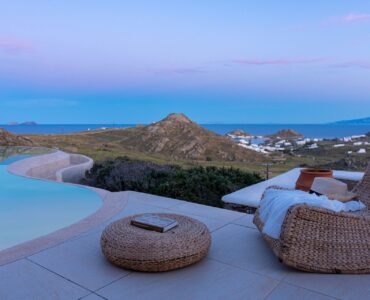 Terrace lounge at dusk with sea view at Tranquil Villa 5 in Kalafatis, Mykonos