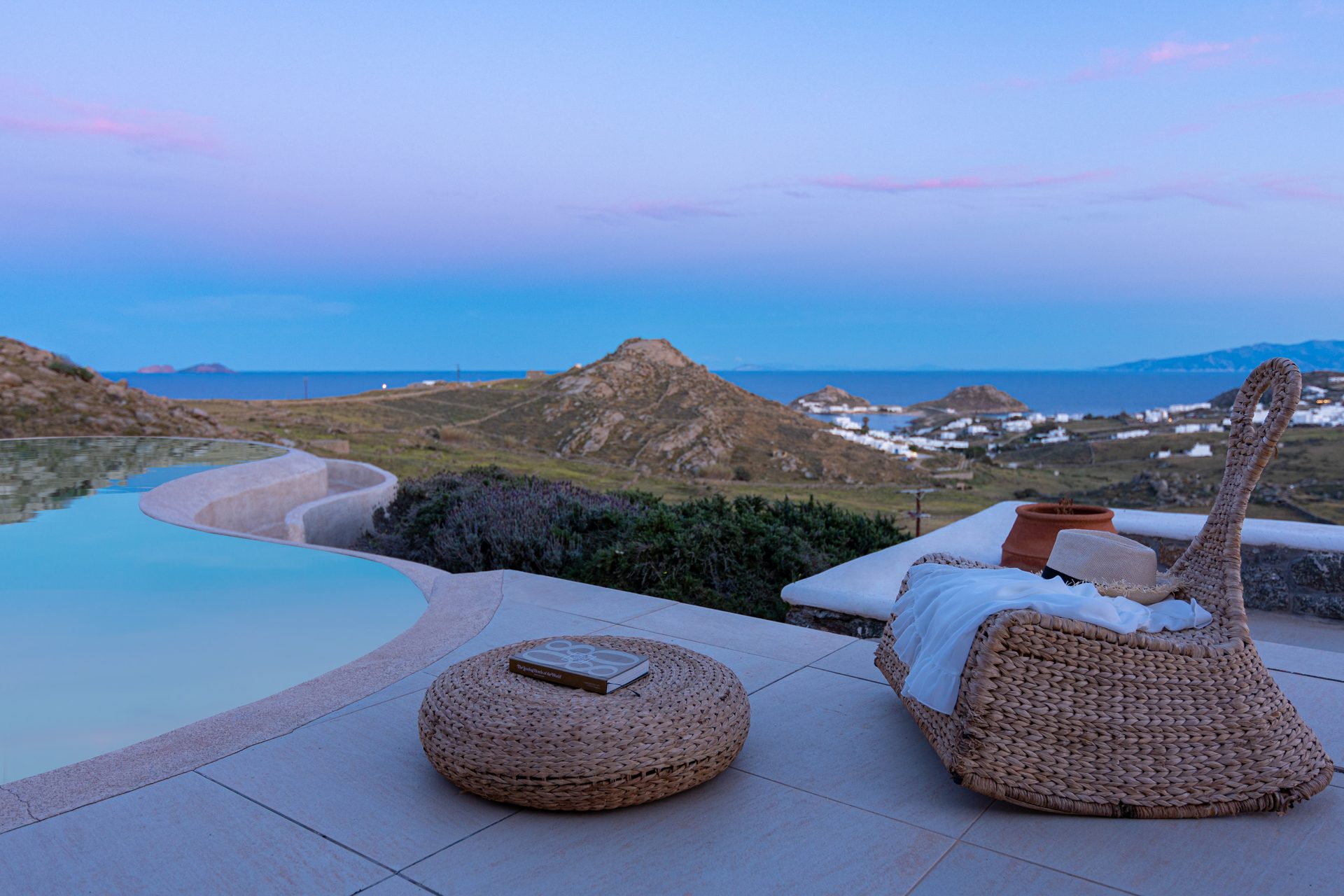 Terrace lounge at dusk with sea view at Tranquil Villa 5 in Kalafatis, Mykonos