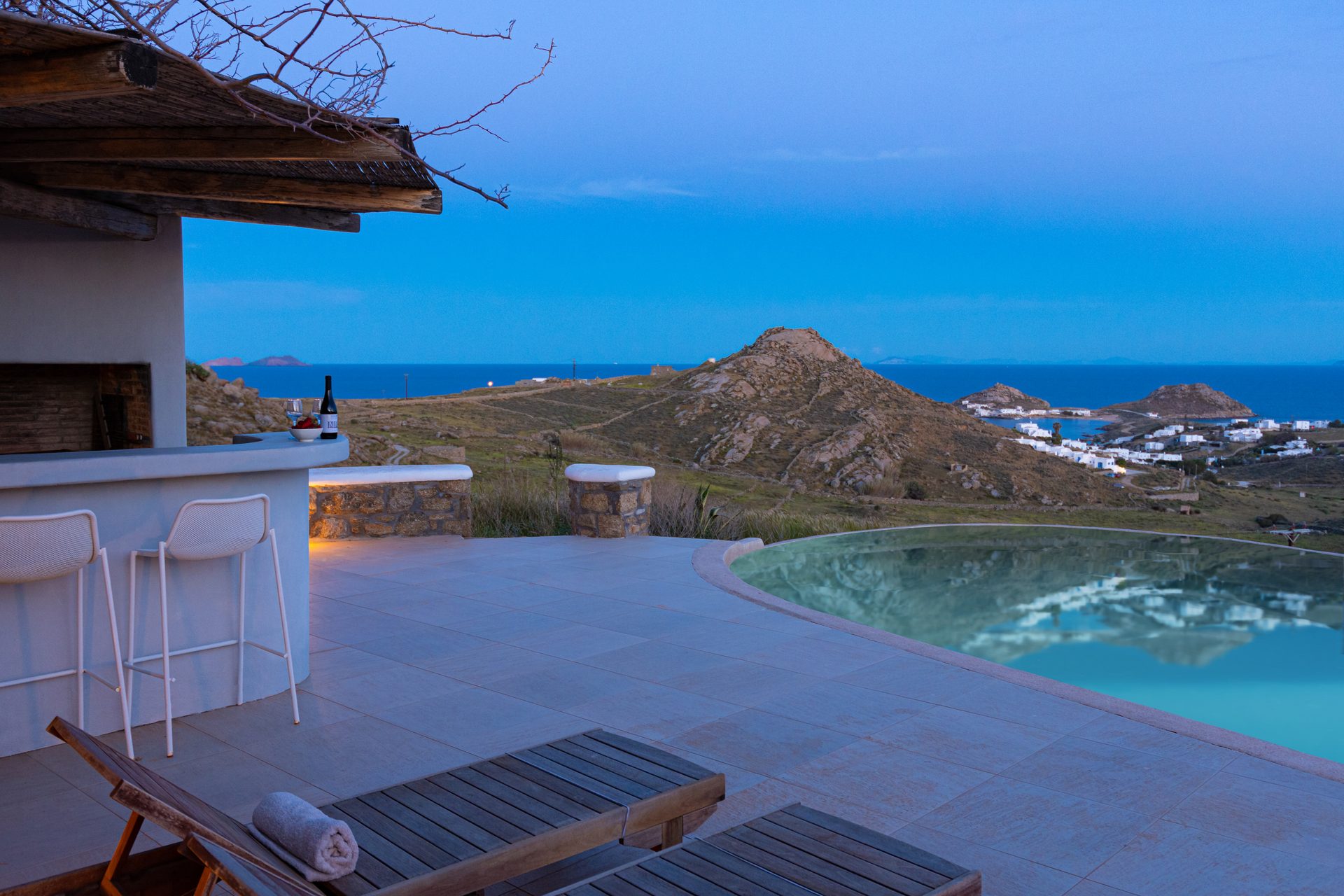 Pool terrace at dusk at Tranquil Villa 5 in Kalafatis, Mykonos