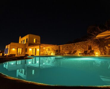Pool lit at night at Tranquil Villa 5 in Kalafatis, Mykonos
