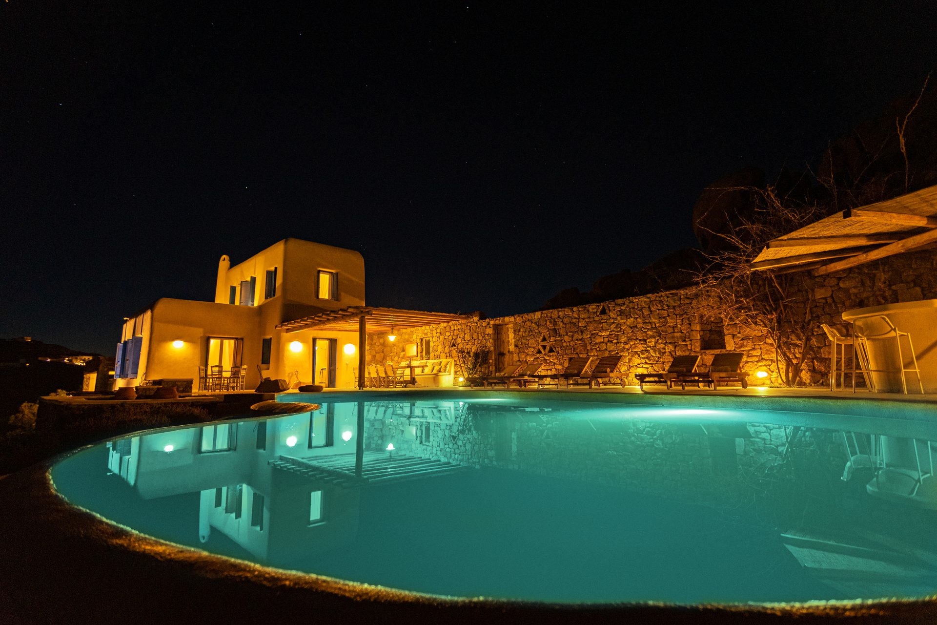 Pool lit at night at Tranquil Villa 5 in Kalafatis, Mykonos