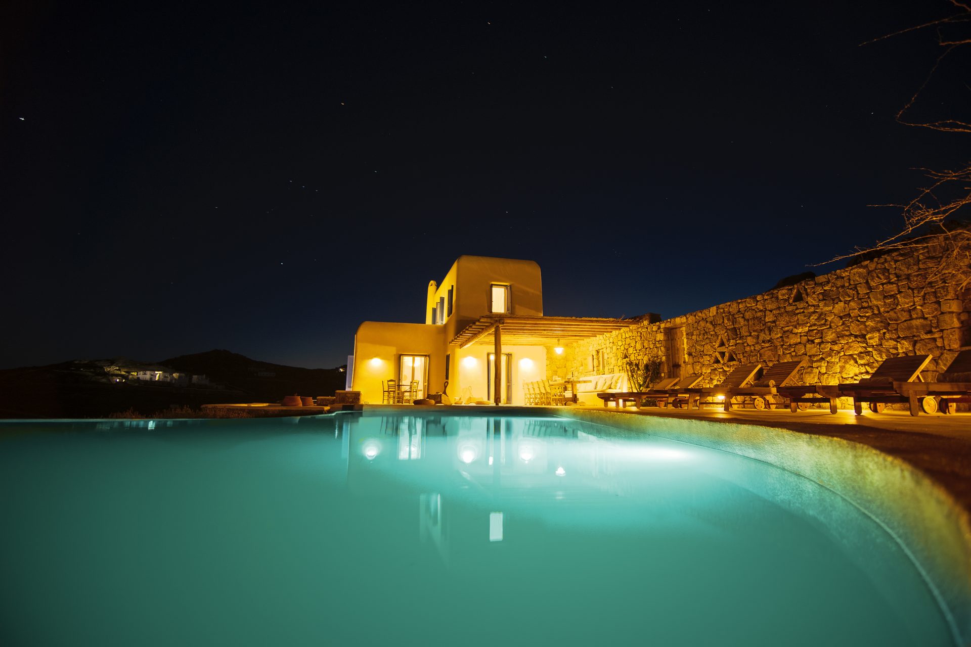 Villa and pool at night at Tranquil Villa 5 in Kalafatis, Mykonos