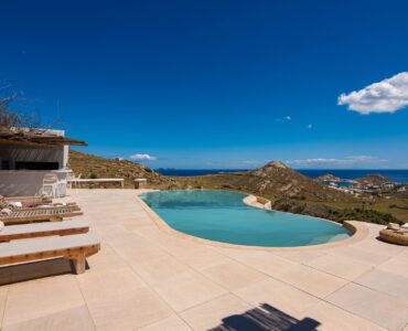 Sun loungers by the pool at Tranquil Villa 5 in Kalafatis, Mykonos