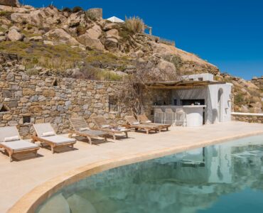 Pool, sun loungers and stone terraces at Tranquil Villa 5 in Kalafatis, Mykonos
