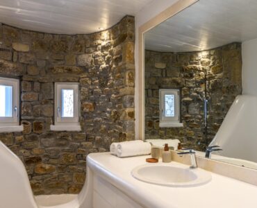 Bathroom with stone wall at Villa Alkioni in Agios Lazaros, Mykonos