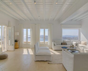 Living room with sea-view windows at Villa Alkioni in Agios Lazaros, Mykonos