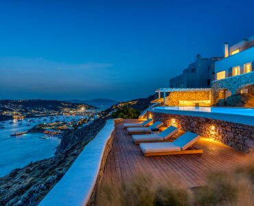 Terrace overlooking Mykonos Town at dusk at Villa Alkioni in Agios Lazaros, Mykonos