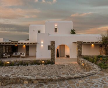 Whitewashed villa and stone garden at dusk at Villa Aloni in Ftelia, Mykonos