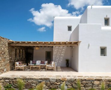 Stone pergola lounge in the garden at Villa Aloni in Ftelia, Mykonos