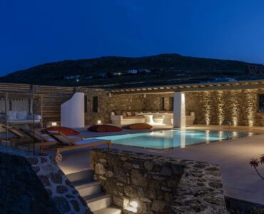 Villa and pool lit at night at Villa Aloni in Ftelia, Mykonos