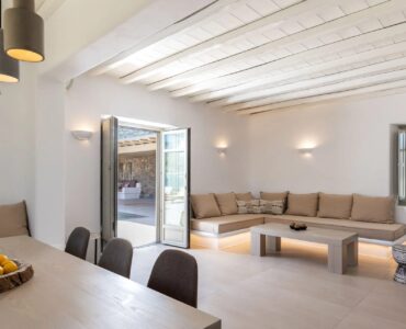 Living room with built-in sofa at Villa Aloni in Ftelia, Mykonos