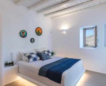 Double bedroom with blue accents at Villa Aloni in Ftelia, Mykonos