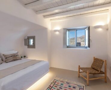 Double bedroom with lounge chair at Villa Aloni in Ftelia, Mykonos