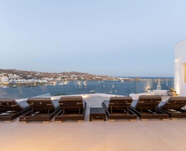 Terrace with sun loungers and bay view at Villa Aquablue in Agios Lazaros, Mykonos