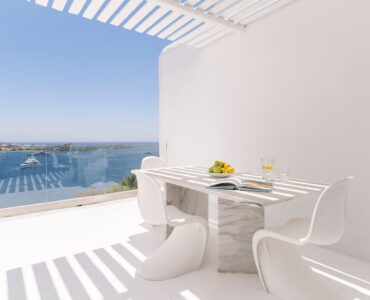 Dining table on the balcony with sea view at Villa Aquablue in Agios Lazaros, Mykonos