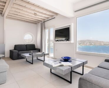 Lounge with picture window and sea view at Villa Aquablue in Agios Lazaros, Mykonos