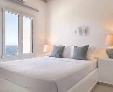 Bedroom with sea-view window at Villa Aquablue in Agios Lazaros, Mykonos