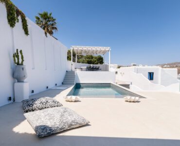 Pool terrace with palm trees at Villa Aquablue in Agios Lazaros, Mykonos