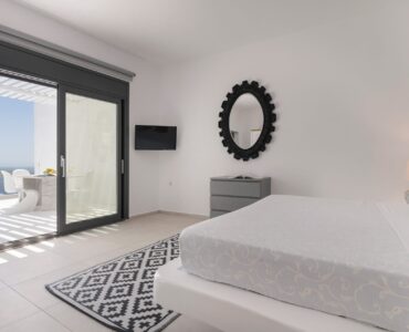 Bedroom with sea-view doors at Villa Aquablue in Agios Lazaros, Mykonos