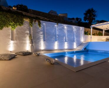 Pool lit at dusk at Villa Aquablue in Agios Lazaros, Mykonos