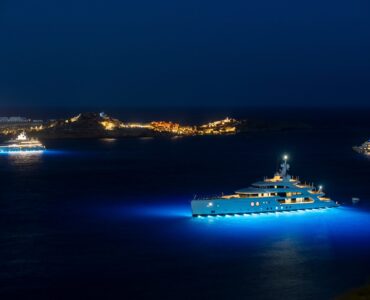 Yachts in the bay at night at Villa Aquablue in Agios Lazaros, Mykonos