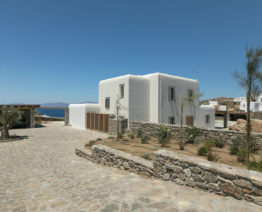 Whitewashed main house and stone walls at Villa Arion in Aleomandra, Mykonos