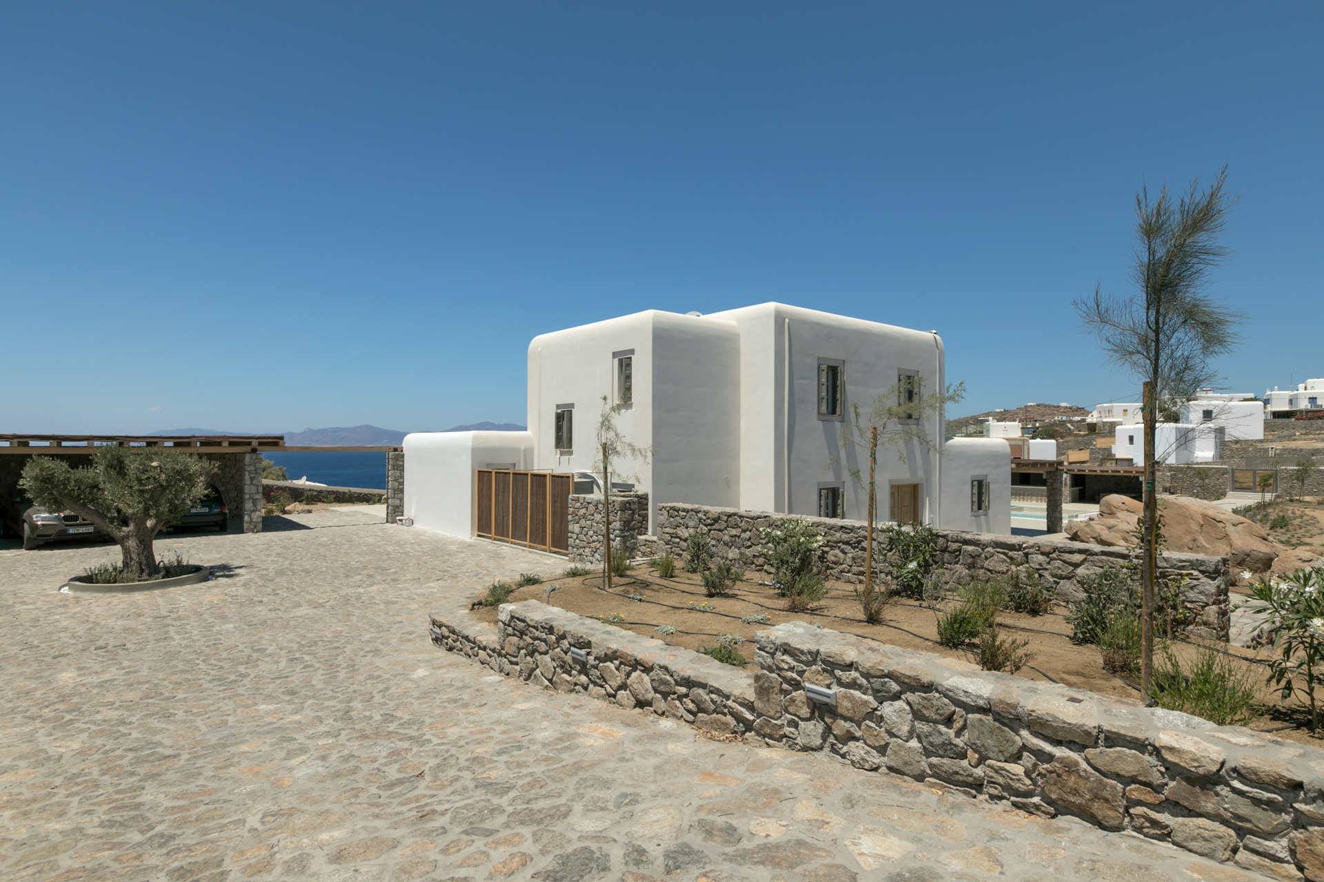 Whitewashed main house and stone walls at Villa Arion in Aleomandra, Mykonos