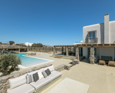 Pool deck with outdoor sofas at Villa Arion in Aleomandra, Mykonos