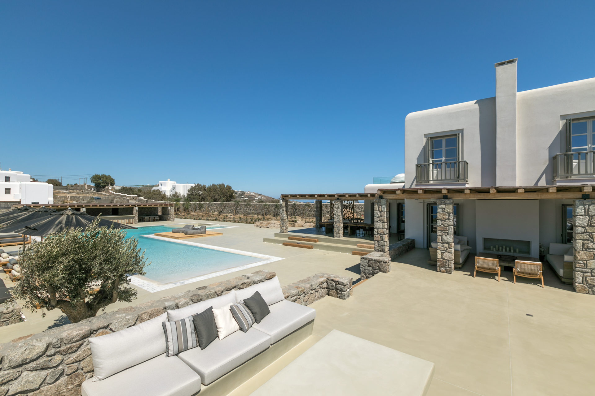 Pool deck with outdoor sofas at Villa Arion in Aleomandra, Mykonos