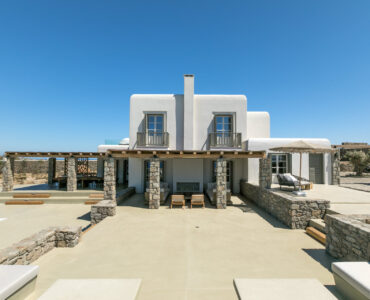 Main house with covered terraces and pool at Villa Arion in Aleomandra, Mykonos