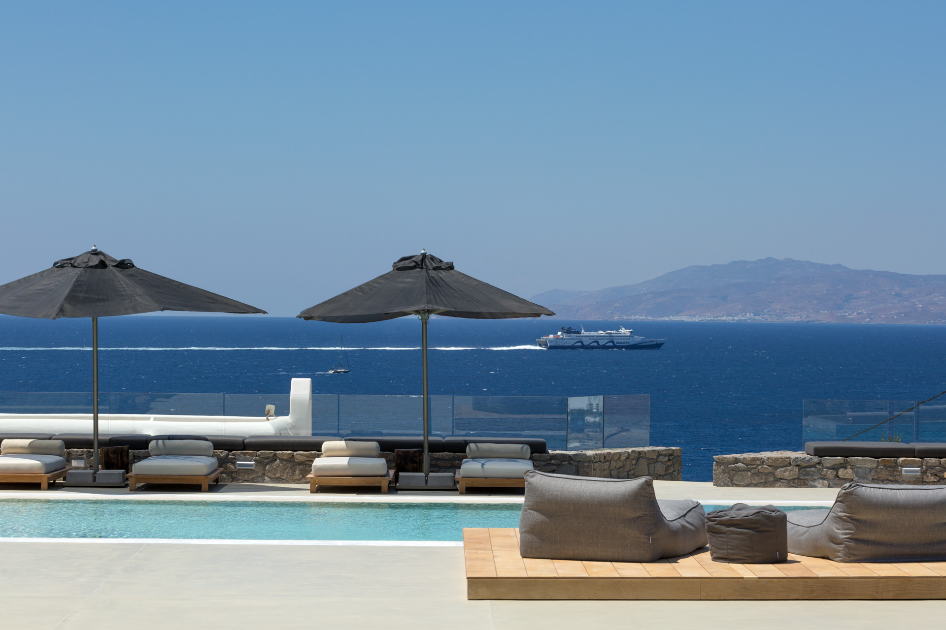 Pool lounge with sea view at Villa Arion in Aleomandra, Mykonos