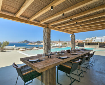 Outdoor dining table under the pergola at Villa Arion in Aleomandra, Mykonos